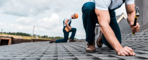 two men working on a roof